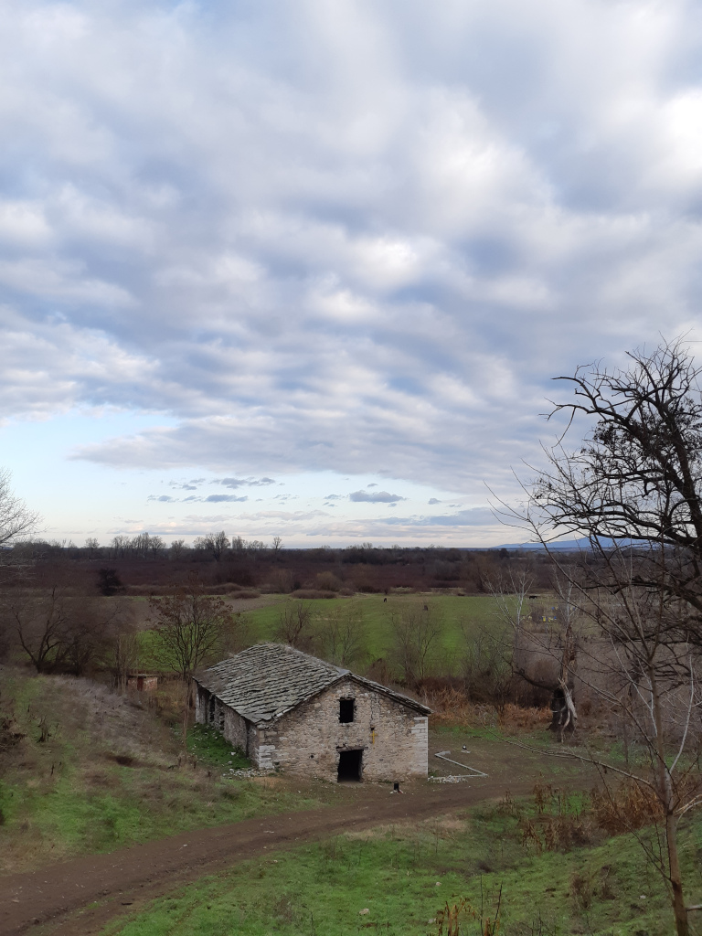 View of an old church down a hill in the fields