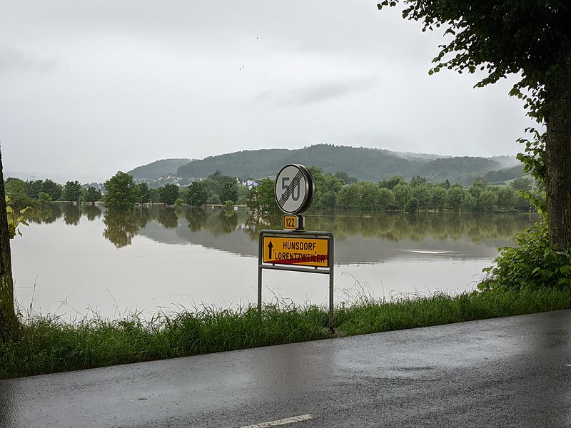 Flooded fields behind road sign