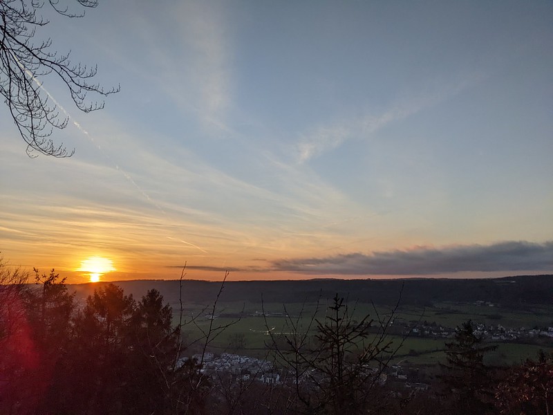 The sun setting over the green valley of the Alzette