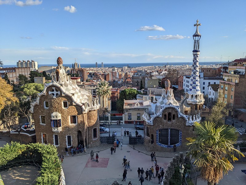 Fantastic view of Gaudi's structures in the parc, overlooking Barcelona with the blue sky and sea in the distance 