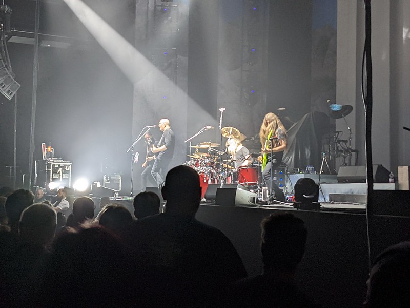 The band on stage against a grey background