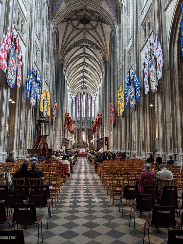 View down the main alley in the cathedral with the different coloured family crests hanging from the sides of the high walls..