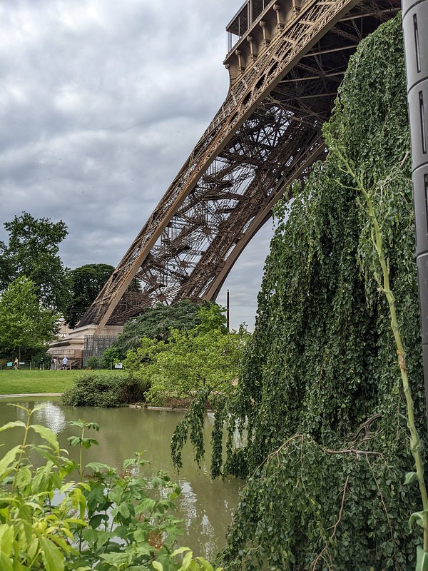 An immense arched foot of the Eiffel Tower