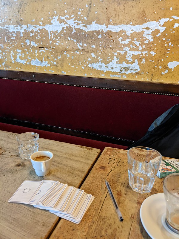 Coffee table with empty glasses, coffee cups and a deck of cards