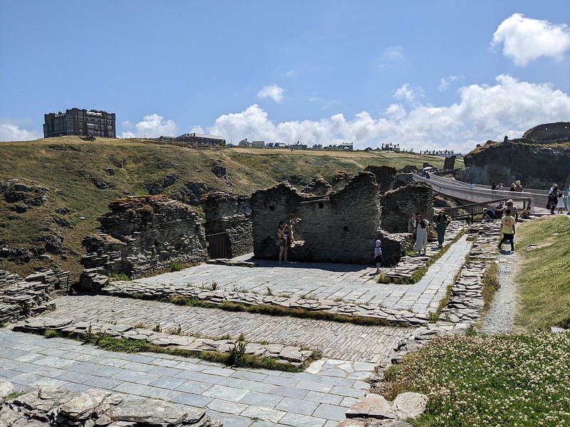 Looking at the ruins of Tintagel Castle with Camelot Castle in the background