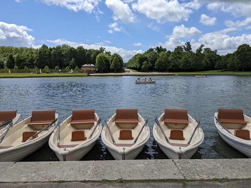 Rowing boats lined up along the pier of the canal.