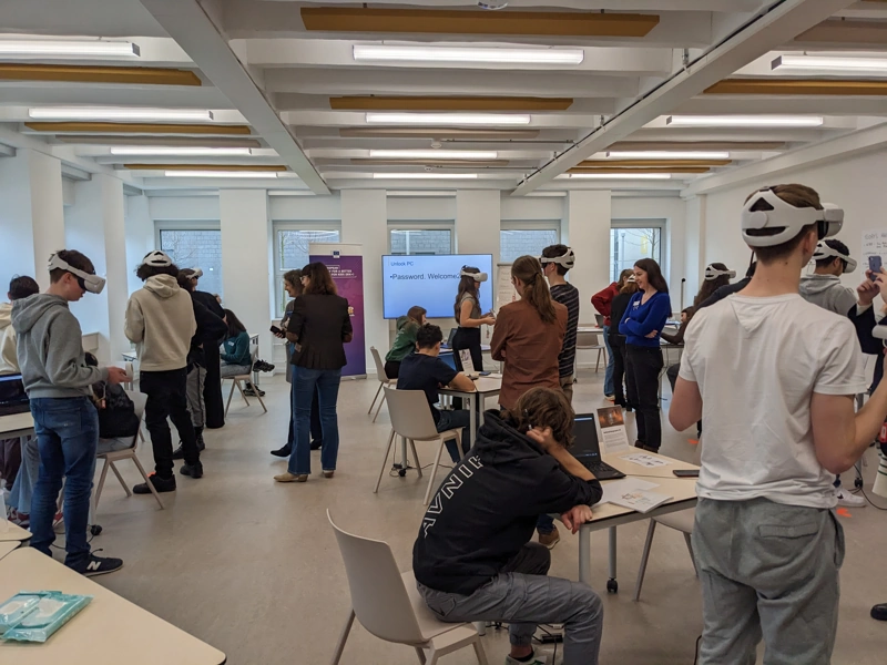 Class room full of teenagers trying out the VR headsets