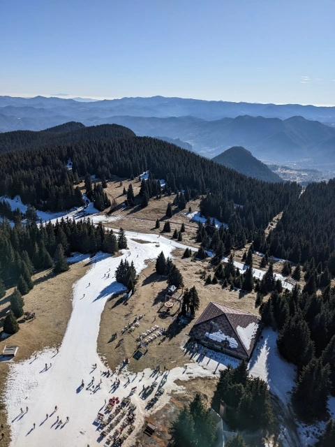 View over the mountains with no snow except for the white ski pistes