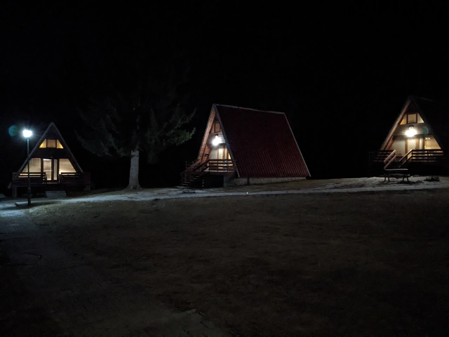 The moutain chalets at night lit up by lights on their terrace