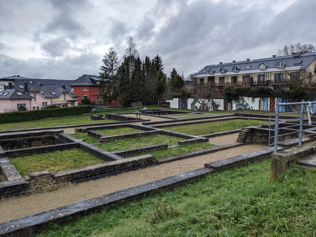 Looking over the outline of a Roman villa clearly showing the layout of the rooms and paths.