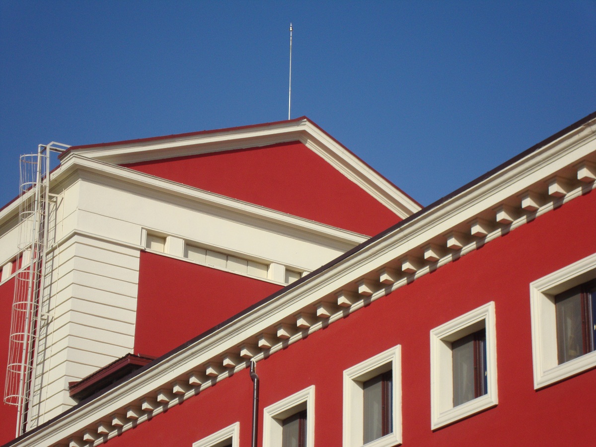 Red building against clear blue sky